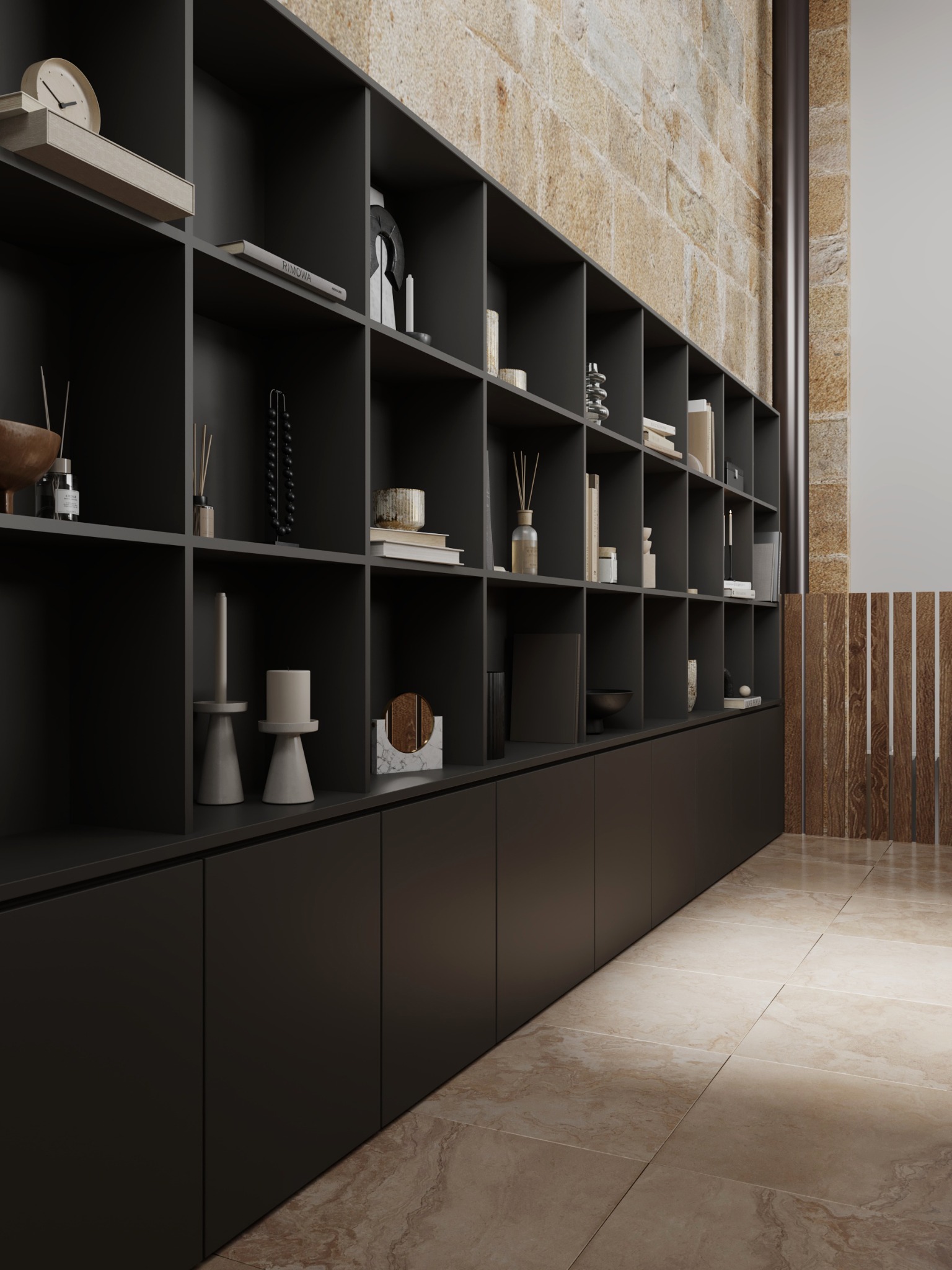 Full-height dark shelving set against exposed limestone