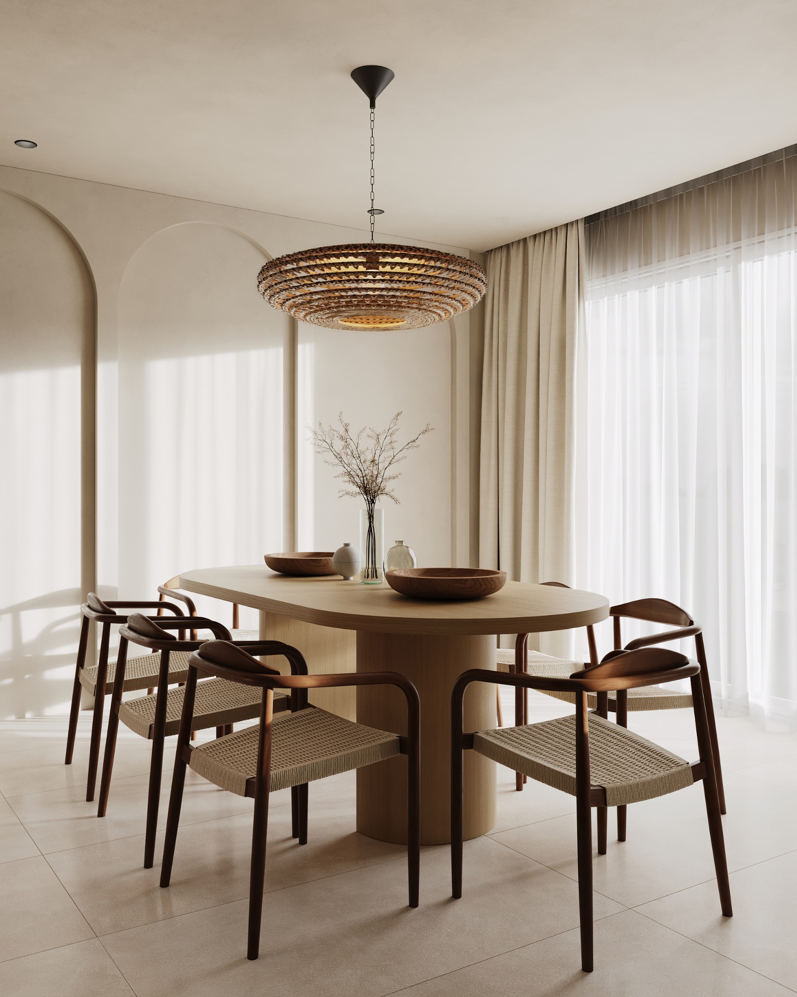 Dining area with round timber table, woven chairs and arched wall details