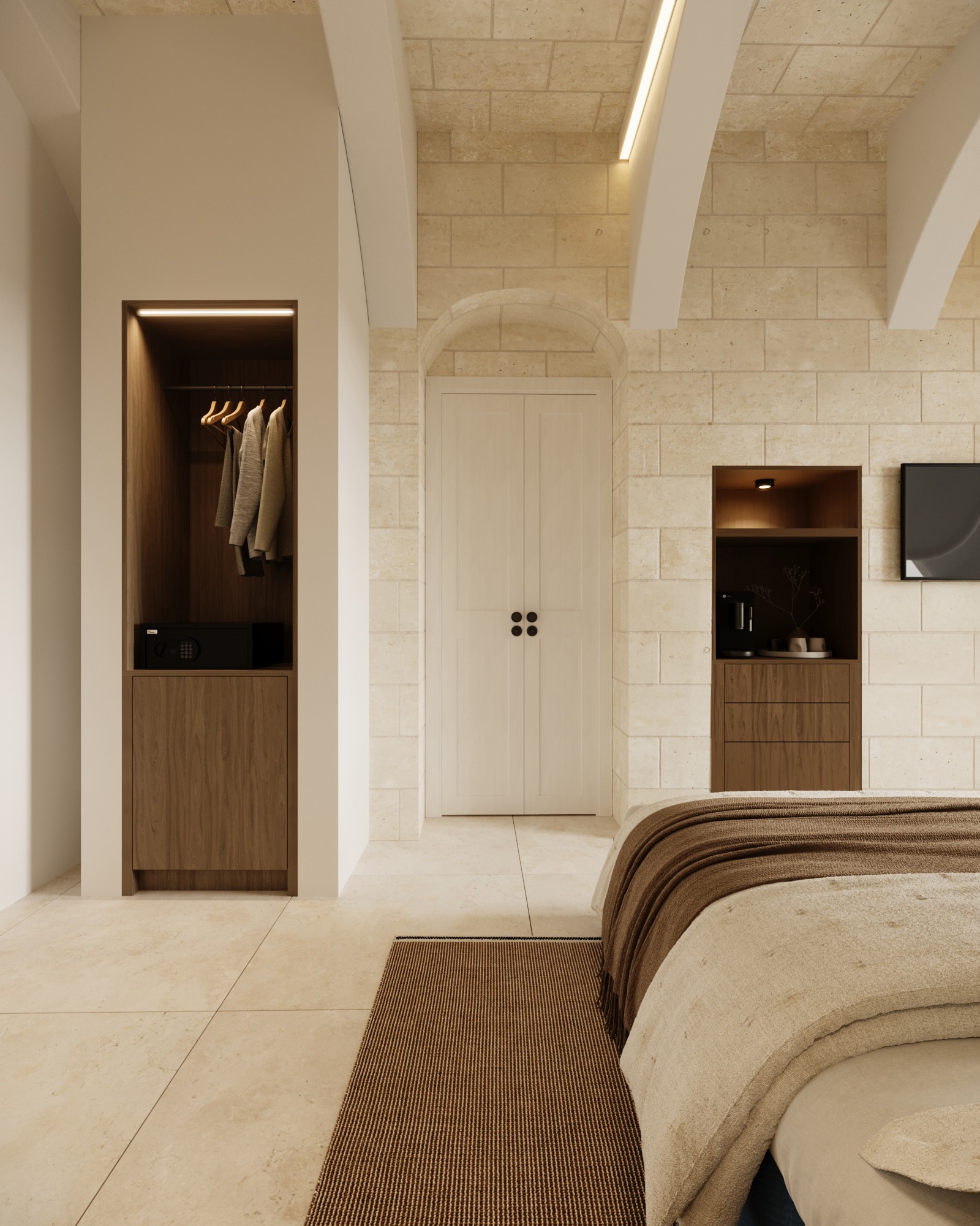 View from the hotel bedroom towards its entrance and fitted storage