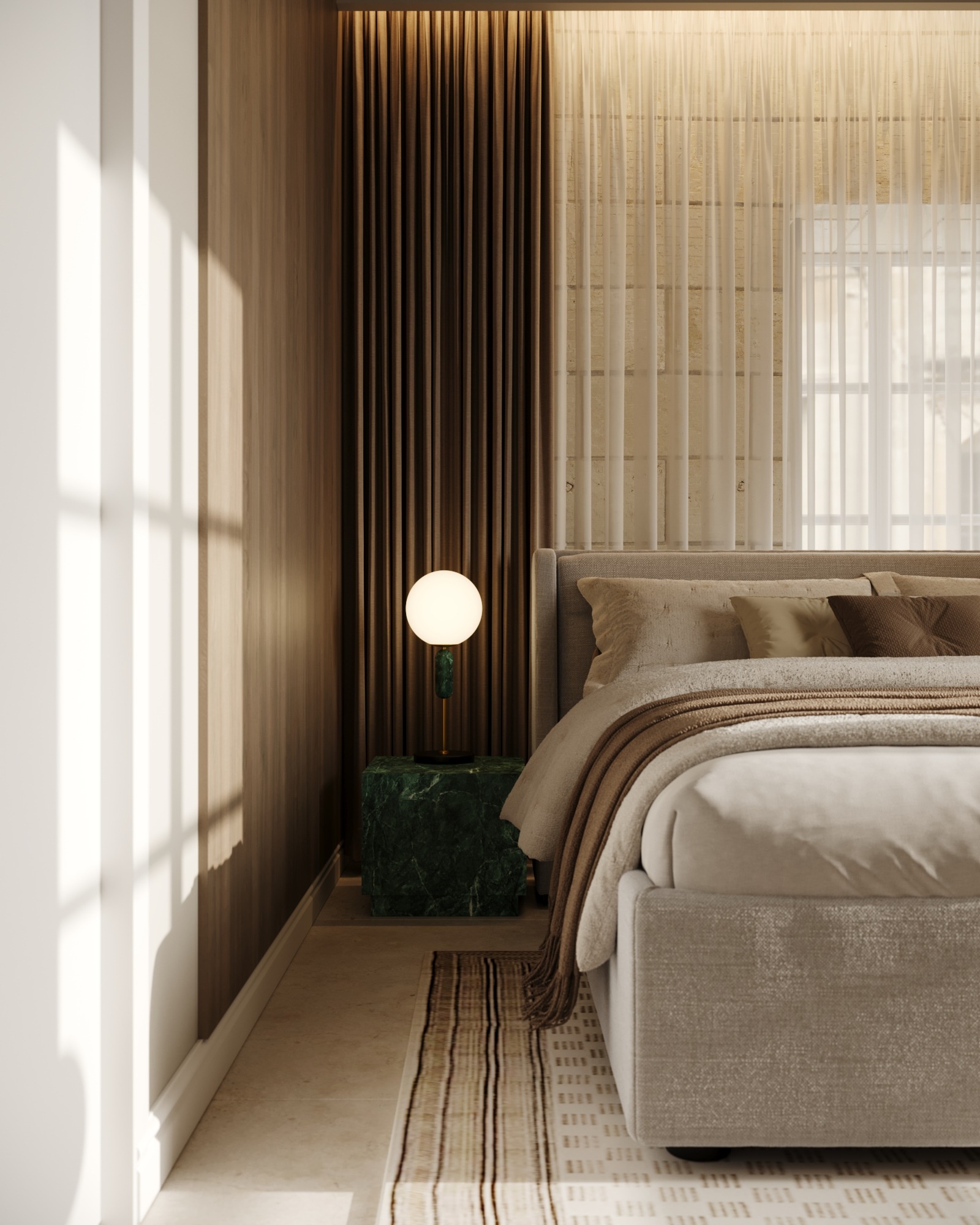 Upholstered bed with green stone bedside table and globe lamp
